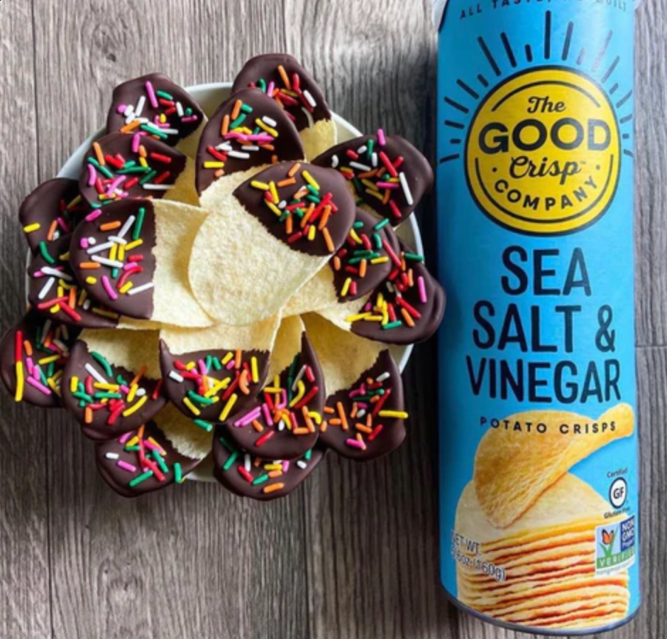 Bowl of chips dipped in chocolate and sprinkles, next to cannister of Sea Salt and Vinegar chips