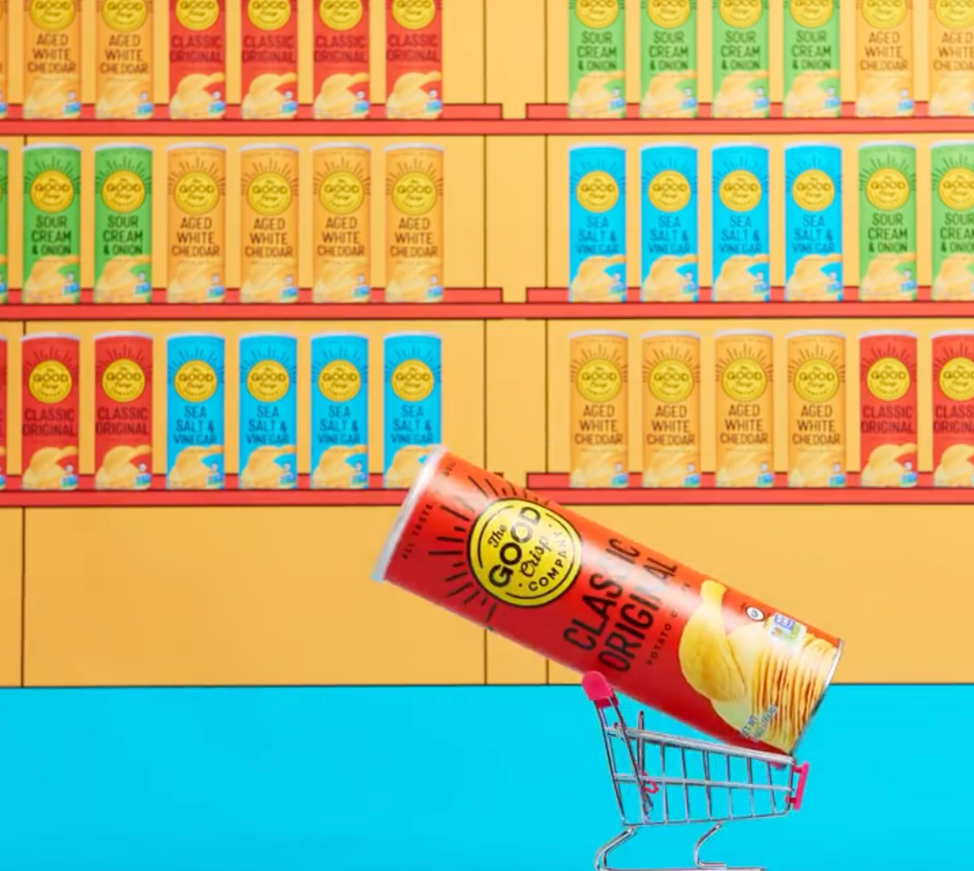 Canister of Classic original in a tiny shopping cart with wall of Good Crisp products behind